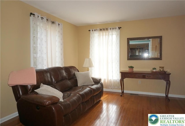 living room featuring wood-type flooring and baseboards
