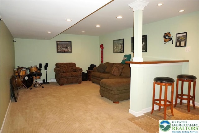 living room with ornate columns, carpet floors, baseboards, a bar, and recessed lighting