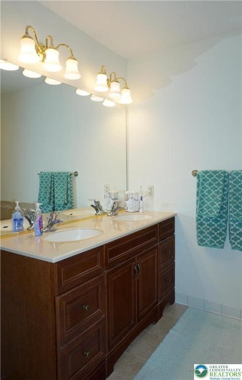 bathroom with double vanity and tile patterned flooring