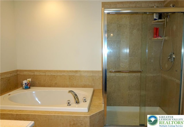 full bath with a stall shower and a bath