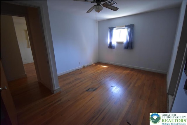 unfurnished bedroom with wood finished floors, baseboards, and ceiling fan