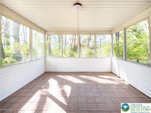 unfurnished sunroom with plenty of natural light