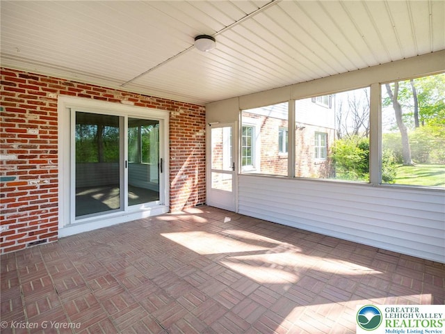 unfurnished sunroom with healthy amount of natural light