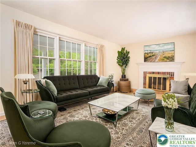 living area featuring a brick fireplace