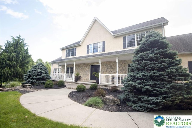 2690 Greens Dr, Lower Saucon Twp, PA 18055 - view of front of property with stone siding, a porch, and stucco siding