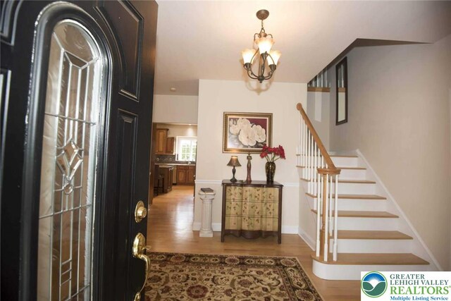 2690 Greens Dr, Lower Saucon Twp, PA 18055 - entrance foyer with a chandelier, wood finished floors, and stairway