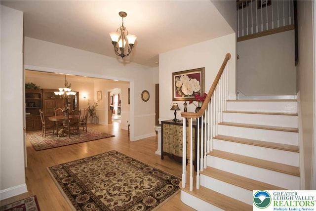 2690 Greens Dr, Lower Saucon Twp, PA 18055 - foyer with a chandelier, stairway, wood finished floors, and baseboards