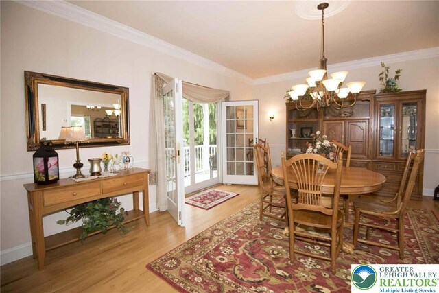 2690 Greens Dr, Lower Saucon Twp, PA 18055 - dining room featuring a chandelier, wood finished floors, and ornamental molding