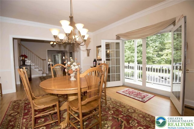 2690 Greens Dr, Lower Saucon Twp, PA 18055 - dining area featuring a chandelier, crown molding, stairs, and wood finished floors