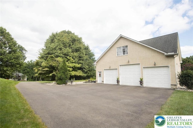 2690 Greens Dr, Lower Saucon Twp, PA 18055 - view of home's exterior with a shingled roof, a garage, stucco siding, and asphalt driveway