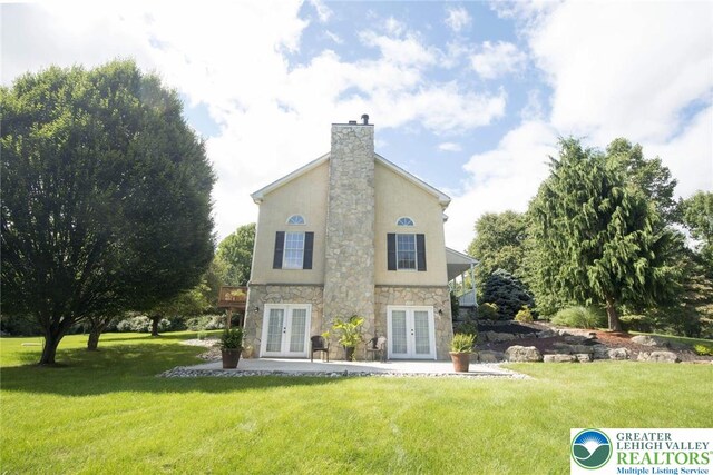 2690 Greens Dr, Lower Saucon Twp, PA 18055 - back of property featuring french doors, stone siding, a yard, and stucco siding