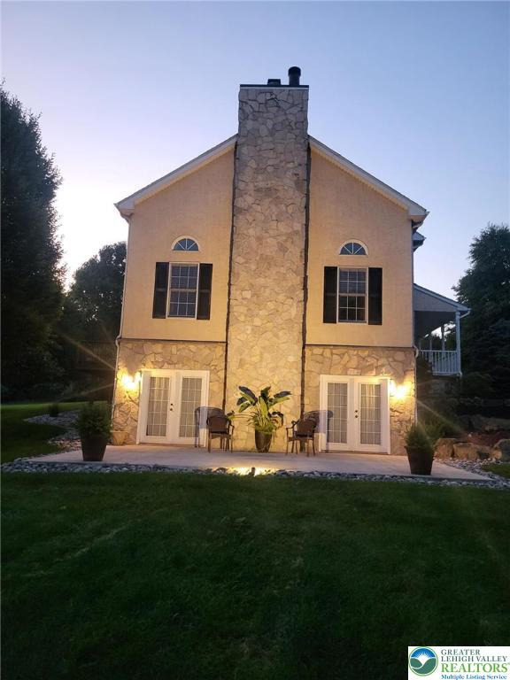 2690 Greens Dr, Lower Saucon Twp, PA 18055 - rear view of property with french doors, stone siding, a yard, and a chimney