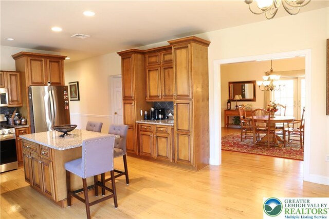 2690 Greens Dr, Lower Saucon Twp, PA 18055 - kitchen with appliances with stainless steel finishes, a chandelier, brown cabinets, and recessed lighting