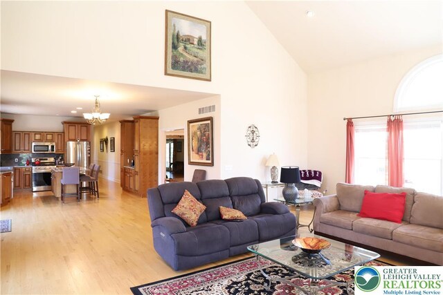 2690 Greens Dr, Lower Saucon Twp, PA 18055 - living area featuring high vaulted ceiling, a chandelier, and light wood-type flooring