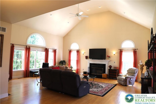 2690 Greens Dr, Lower Saucon Twp, PA 18055 - living room with high vaulted ceiling, a glass covered fireplace, a ceiling fan, and wood finished floors