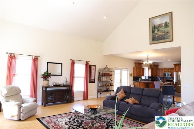 2690 Greens Dr, Lower Saucon Twp, PA 18055 - living room with a chandelier, light wood-style floors, high vaulted ceiling, baseboards, and recessed lighting