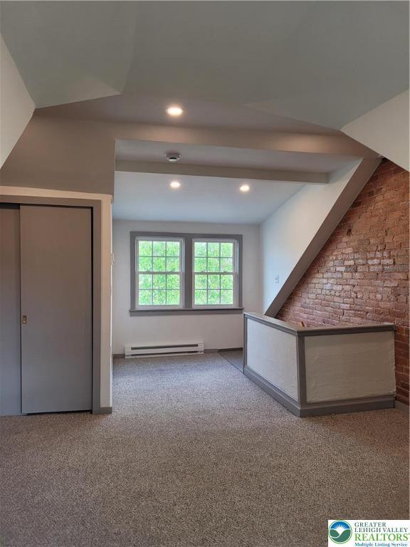 bonus room featuring baseboard heating, carpet, recessed lighting, and brick wall