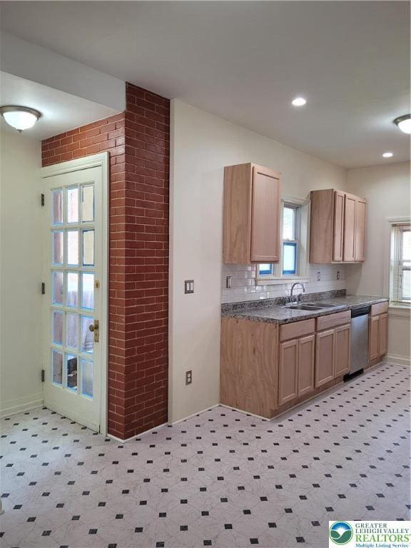 kitchen featuring a sink, dishwasher, healthy amount of natural light, baseboards, and recessed lighting