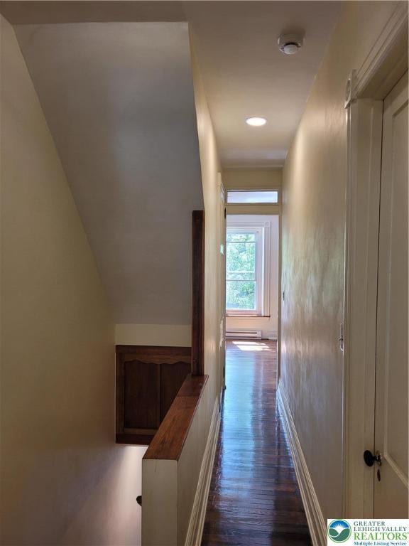 corridor featuring dark wood-style floors, baseboards, and baseboard heating