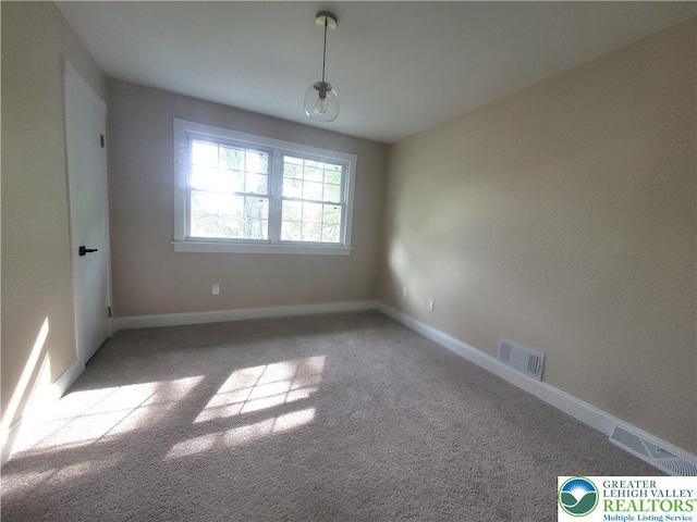 empty room with carpet flooring and baseboards