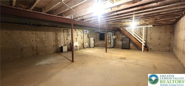 unfinished basement with water heater, heating unit, and a sink