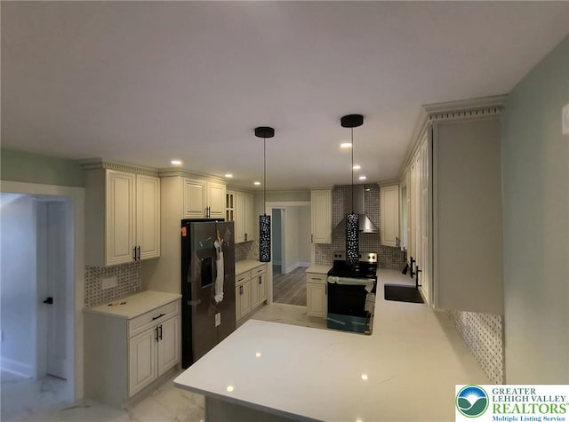 kitchen with electric stove, black fridge with ice dispenser, tasteful backsplash, a sink, and light countertops