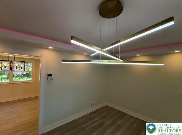 empty room with a chandelier, dark wood finished floors, baseboards, and recessed lighting