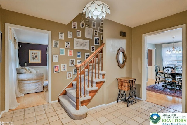 1245 Valley View Dr, Lower Macungie Twp, PA 18103 - stairs featuring a chandelier, tile patterned floors, and baseboards