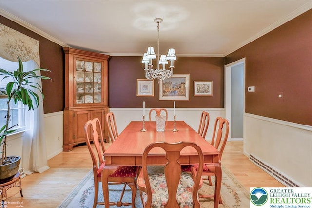 1245 Valley View Dr, Lower Macungie Twp, PA 18103 - dining space featuring light wood-style floors, a chandelier, a wainscoted wall, and ornamental molding
