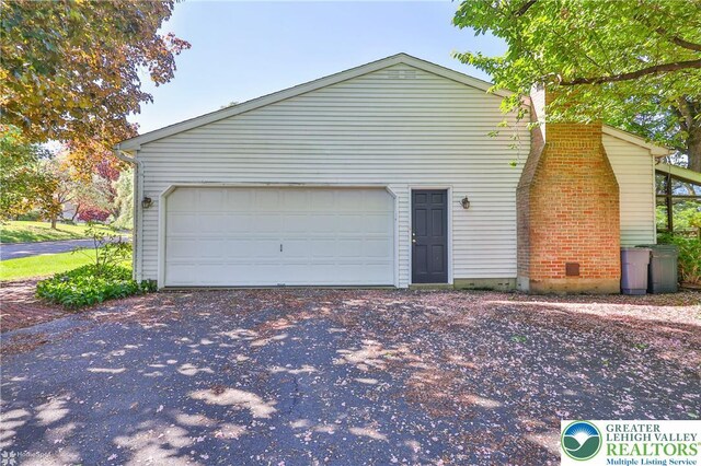 1245 Valley View Dr, Lower Macungie Twp, PA 18103 - view of side of home with a garage