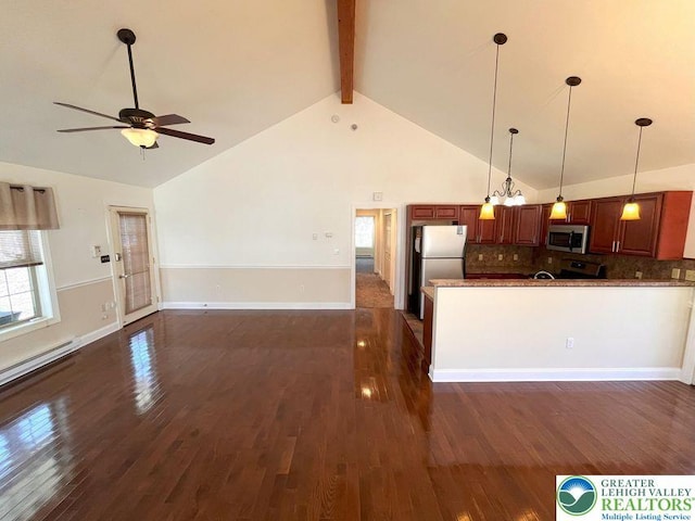 kitchen with stainless steel appliances, open floor plan, a ceiling fan, pendant lighting, and plenty of natural light