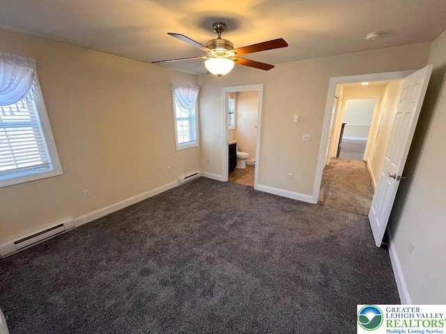 unfurnished bedroom featuring dark colored carpet, a baseboard radiator, baseboard heating, ensuite bath, and baseboards