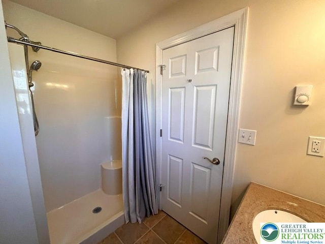 full bathroom with tile patterned floors and a shower with shower curtain