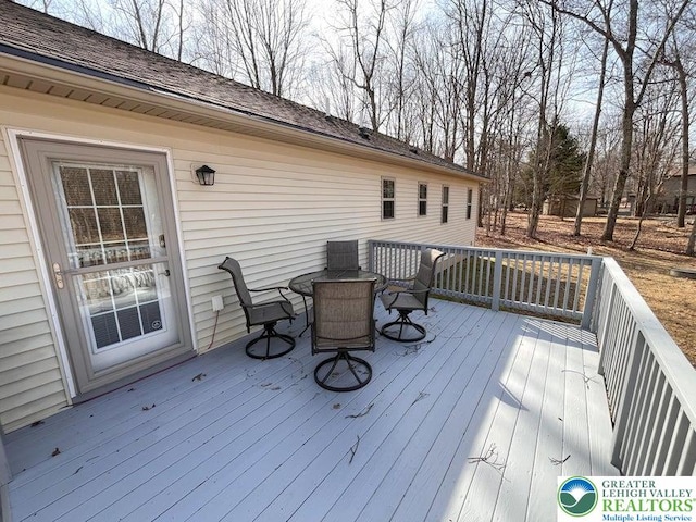 wooden deck with outdoor dining space