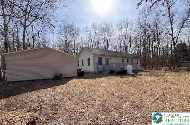 rear view of property with a wooden deck