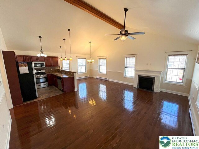 unfurnished living room with a chandelier, a ceiling fan, dark wood-style floors, a sink, and a fireplace with flush hearth