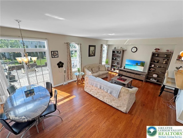 4527 Bellflower Way, Upper Macungie Twp, PA 18104 - living room with a chandelier, wood finished floors, and baseboards