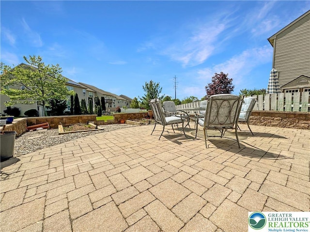 4527 Bellflower Way, Upper Macungie Twp, PA 18104 - view of patio / terrace featuring outdoor dining space, fence, and a residential view