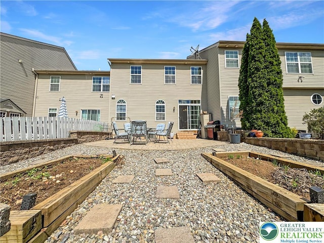 4527 Bellflower Way, Upper Macungie Twp, PA 18104 - rear view of property with a vegetable garden, a patio area, fence, and entry steps
