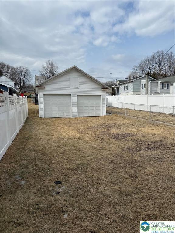 view of yard with a garage and an outdoor structure