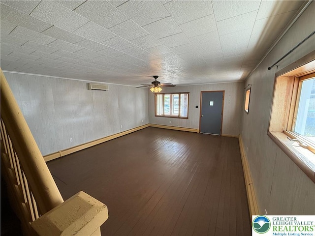 unfurnished living room featuring hardwood / wood-style flooring and ceiling fan
