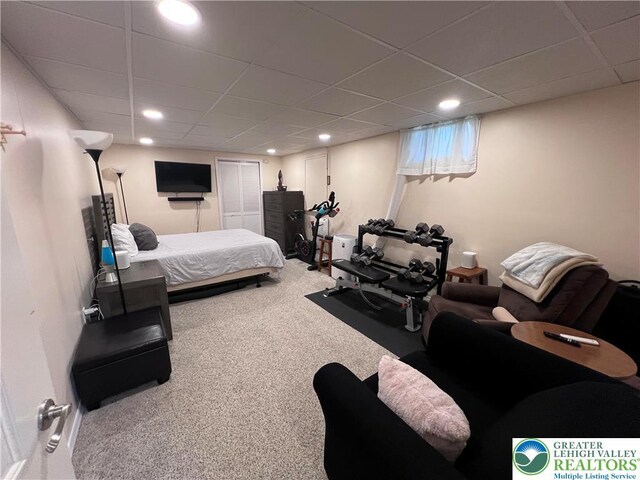 carpeted bedroom with recessed lighting and a paneled ceiling