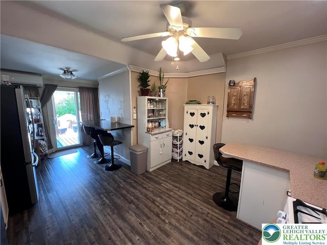 office with dark wood-type flooring, ornamental molding, ceiling fan, a wall unit AC, and baseboards