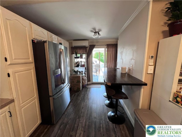 kitchen featuring stainless steel refrigerator with ice dispenser, ornamental molding, dark wood-style floors, a wall mounted air conditioner, and dark countertops
