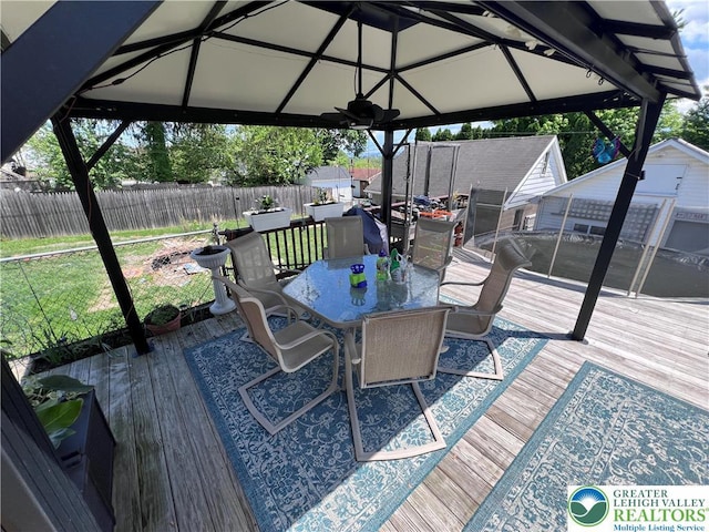 deck with a gazebo and outdoor dining area