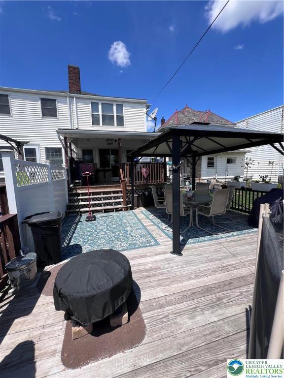 wooden deck featuring outdoor dining space and fence