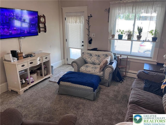 carpeted living room with a baseboard radiator, plenty of natural light, and baseboards