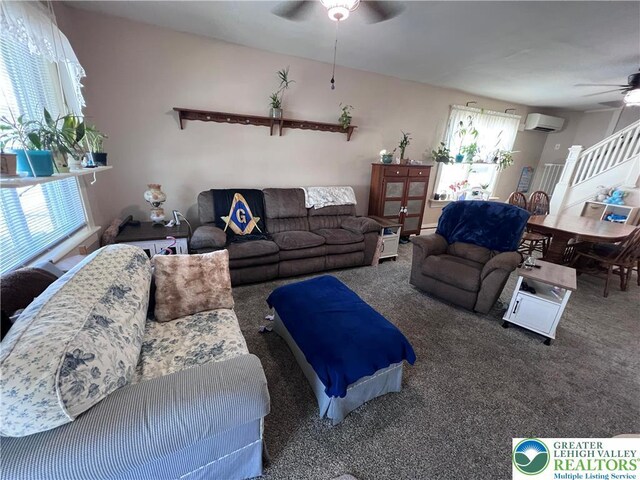 living room with a ceiling fan, an AC wall unit, and carpet floors