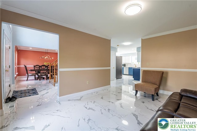 living area featuring crown molding, baseboards, light marble finish flooring, and a chandelier