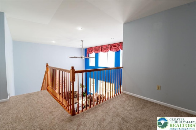hallway with carpet flooring, baseboards, and recessed lighting
